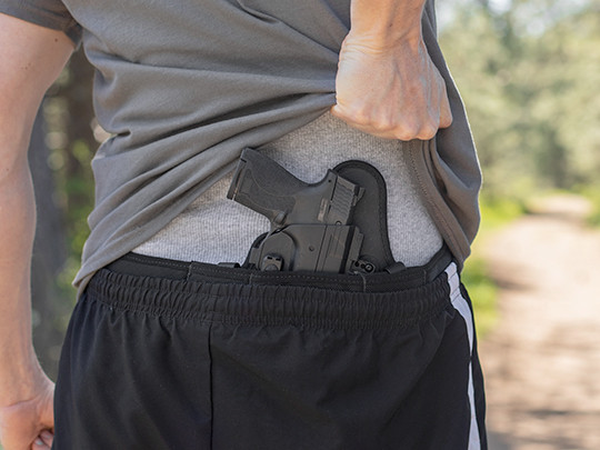 Man conceal carrying IWB small of back