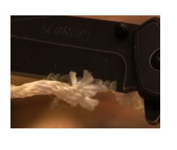 example of serrated edge blade pocket knife cutting rope