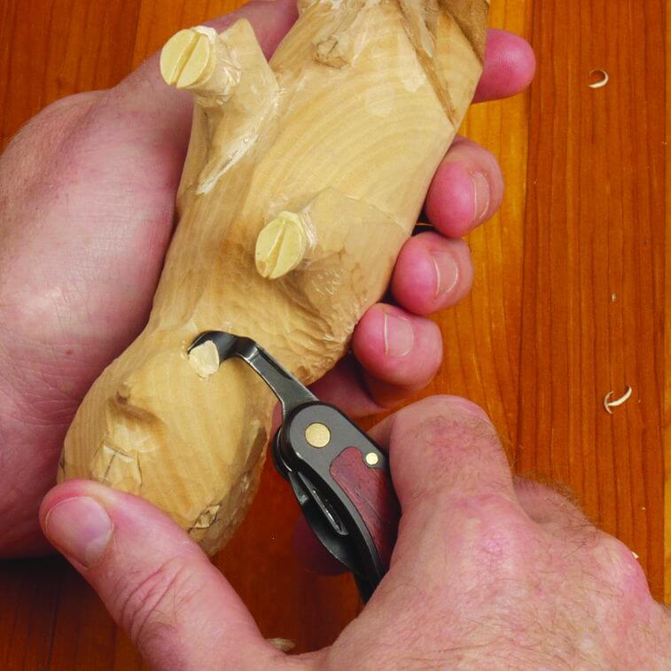 Carving wooden object with pocket knives